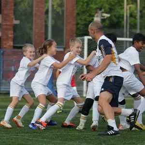 Younger group celebrating with a coach