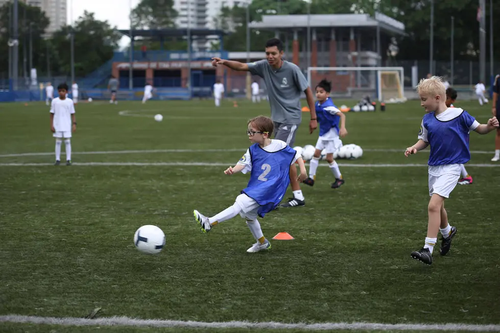 Striking through the ball as the coach guides play